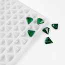 Close-up of a 2mL diamond gummy mold with 179 cavities and emerald green gummies on a white background