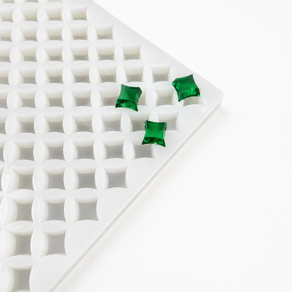 Close-up of a 2mL star gummy mold with 192 cavities and emerald green gummies on a white background